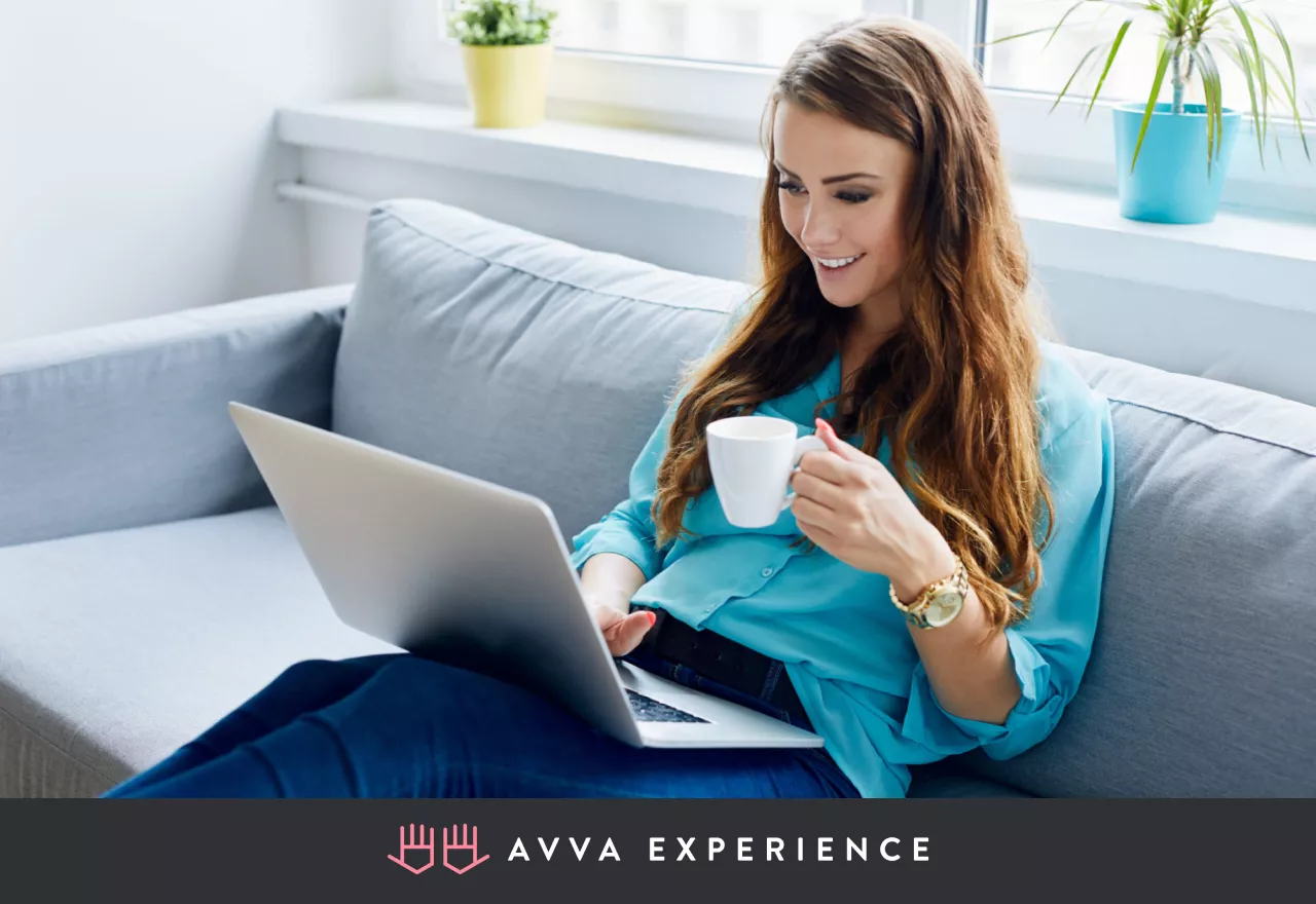 Woman smiling while participating in an online meeting