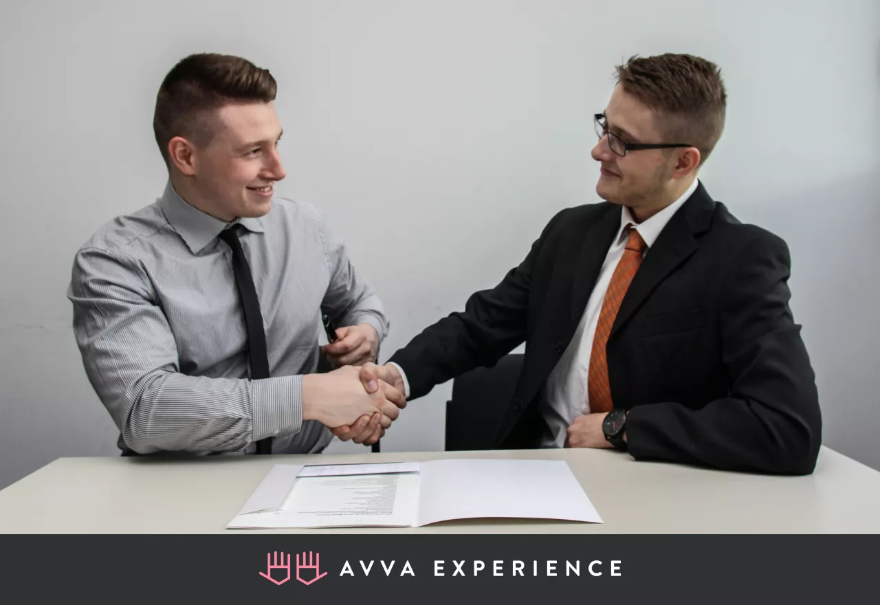 A business owner and a client shaking hands in an office