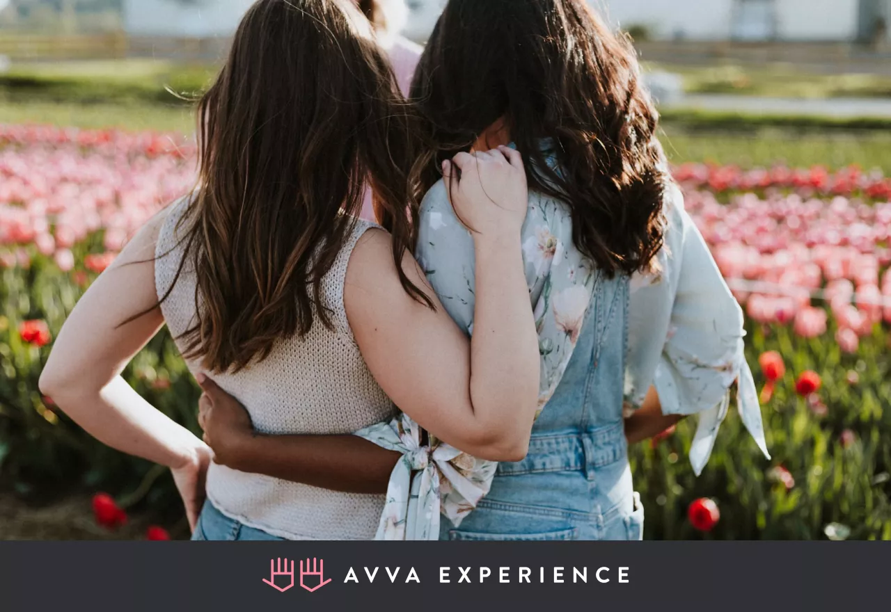 Women hugging and celebrating together during a Women’s History Month event