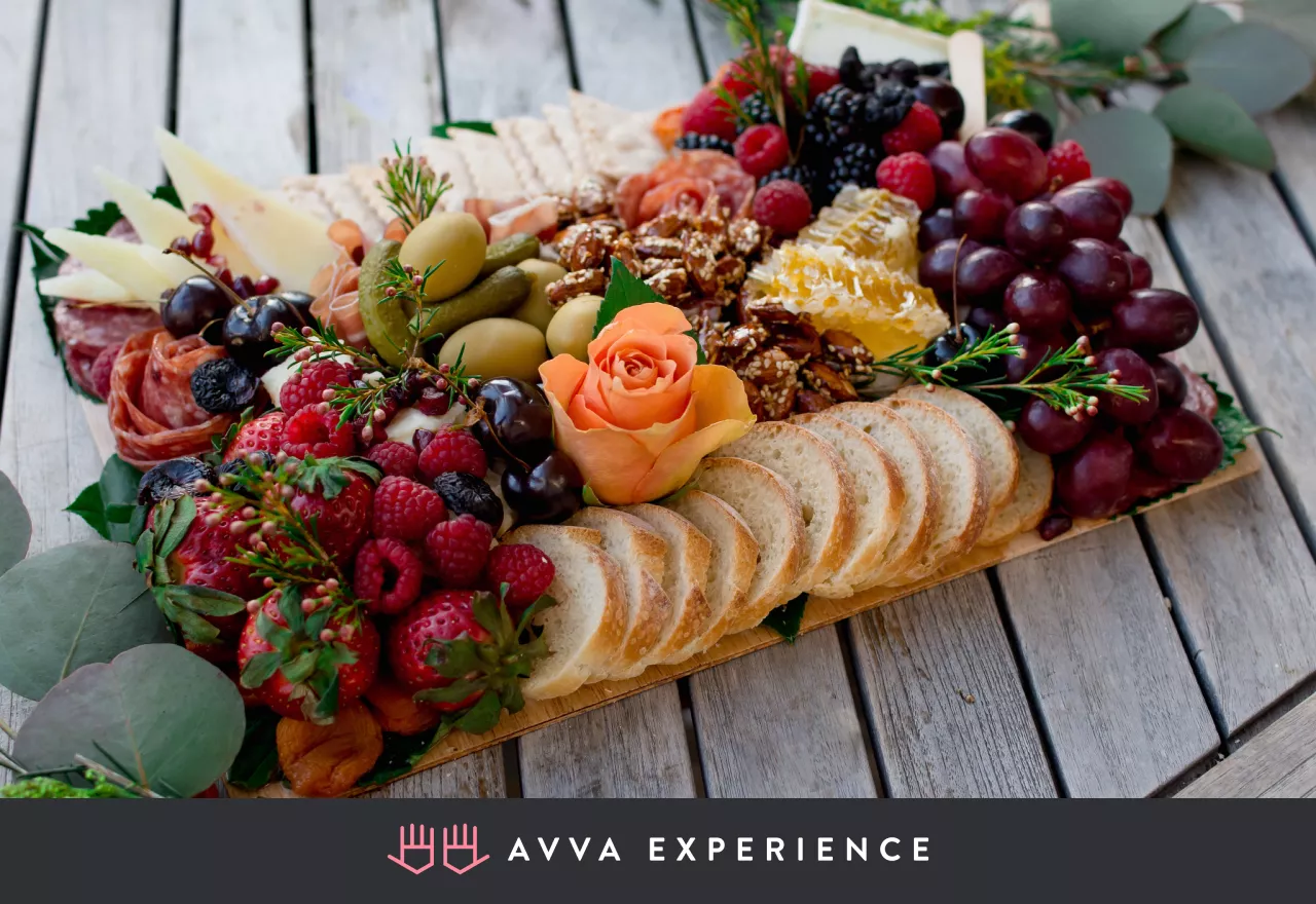 Charcuterie board with cheeses, meats, bread, fruit, and nuts