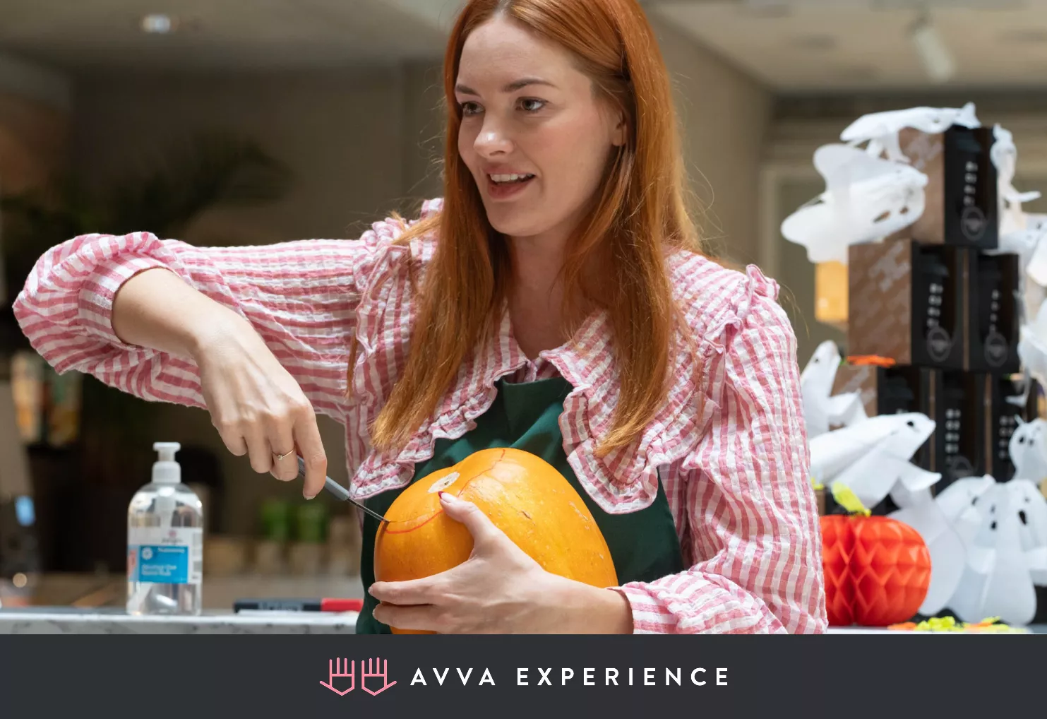 Woman carving a pumpkin