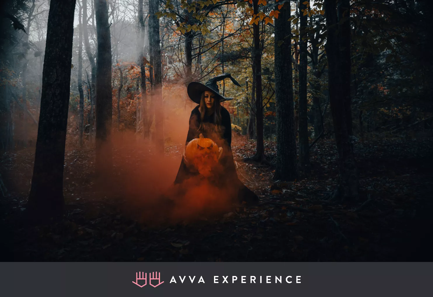 Witch holding a Halloween pumpkin